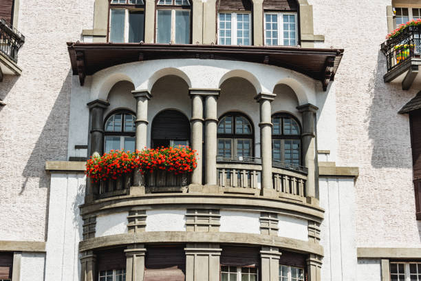 Vintage mansion balcony with columns. Luxury historic home with windows and terrace