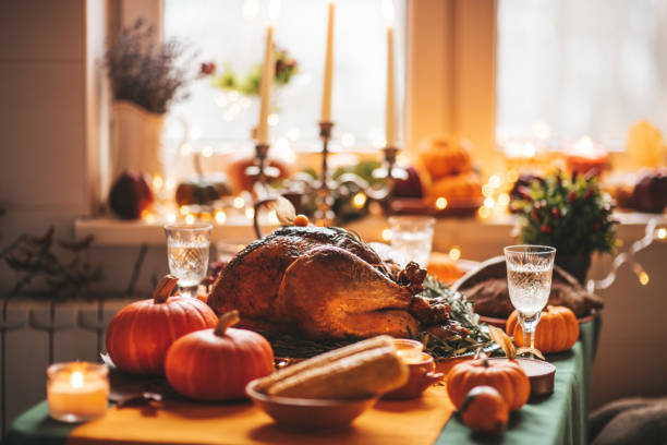 istock Thanksgiving holiday dinner table setting with fall decoration and pumpkins 1444237557