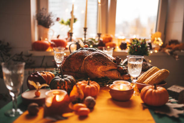 istock Thanksgiving holiday dinner table setting with fall decoration and pumpkins 1444237561