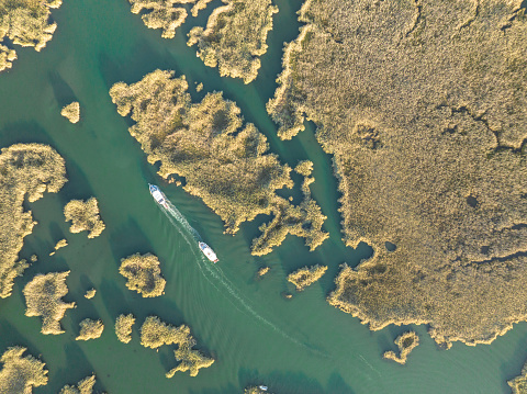 Daily tour boat on Dalyan delta in Muğla, Türkiye. Taken via drone.