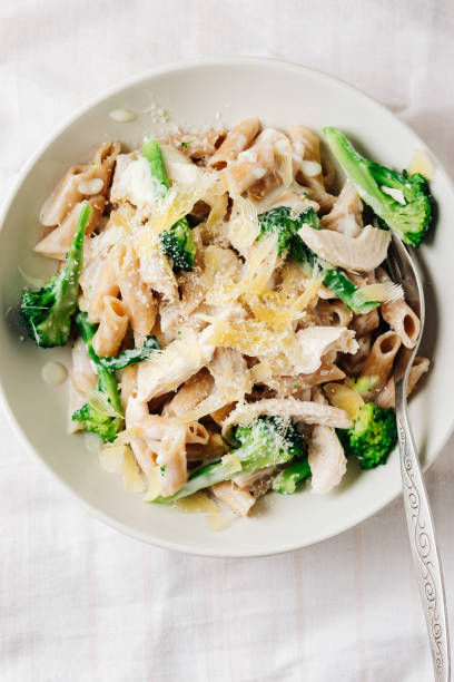 istock Whole grain penne pasta with chicken and green vegetables. 1444238628