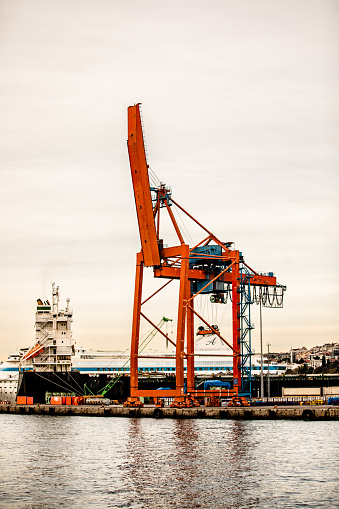 New Bedford, Massachusetts, USA - July 12, 2019: Workers readying wind turbine blades for unloading from cargo vessel Annemieke at Marine Commerce Terminal in New Bedford