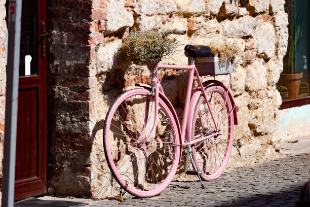istock Pink bike leaning on old wall 1444242436