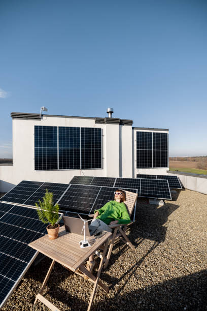 istock Woman works on a rooftop with a solar power plant 1444244717