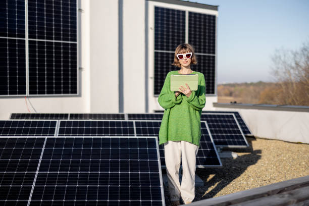 istock Woman with digital tablet on rooftop with solar plant 1444245671