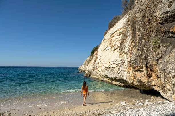 Woman on a stunning Beach in Himare, Albania stock photo