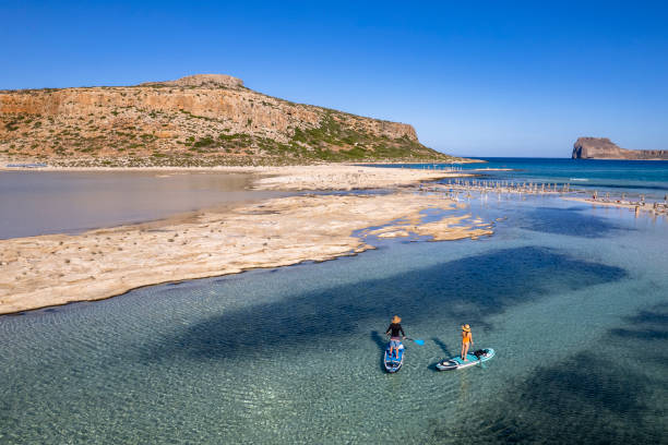 istock Couple paddle boarding on vacation 1444246046
