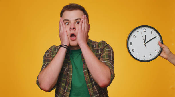 istock Confused man with anxiety checking time on clock, running late to work, being in delay, deadline 1444248051