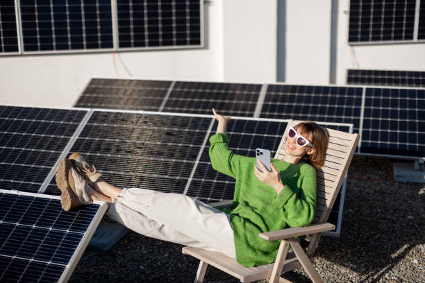 istock Happy woman on rooftop with a solar station 1444248192