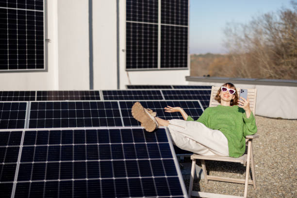 istock Happy woman on rooftop with a solar station 1444248239