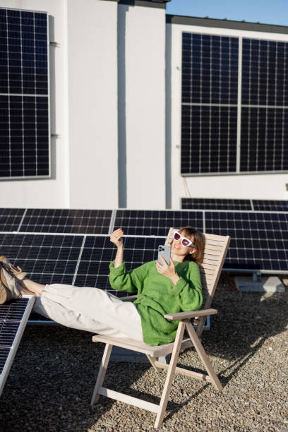 istock Happy woman on rooftop with a solar station 1444248280