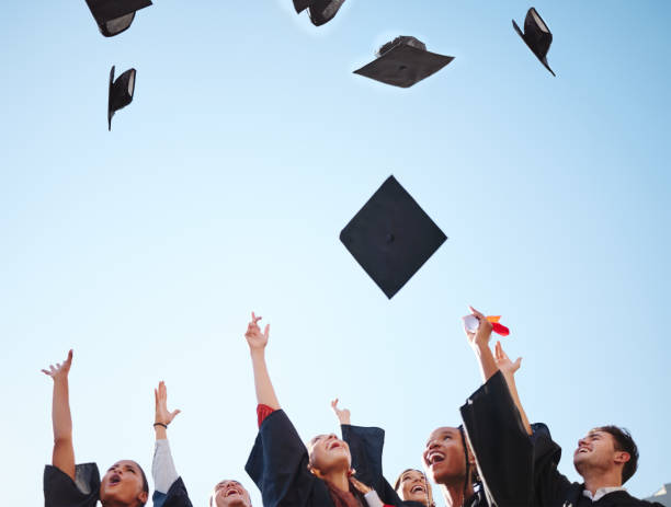 istock Graduation, students and graduate class throw caps in air feeling happy about education success at the ceremony. University or college men and women d friends celebrate proud certificate achievement 1444248727