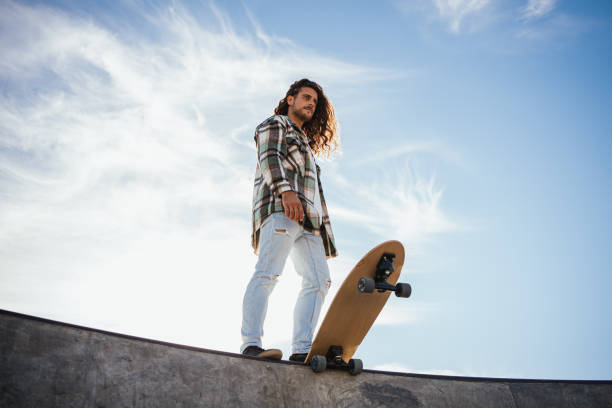 istock Man holding his skateboard with his foot 1444251086