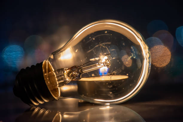 istock A candle burns instead of a light bulb, saving energy 1444253488