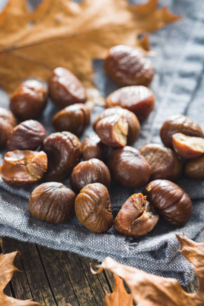 istock Peeled chestnuts. Sweet roasted chestnuts on cutting board. 1444254845