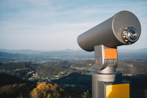 Tourist binocular on a hill in Slovenia stock photo. Modern binocular on a hill stock. Telescope on the hills.