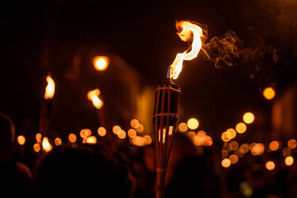 istock Burning Torch at Night in a procession. Bokeh. 1444260223