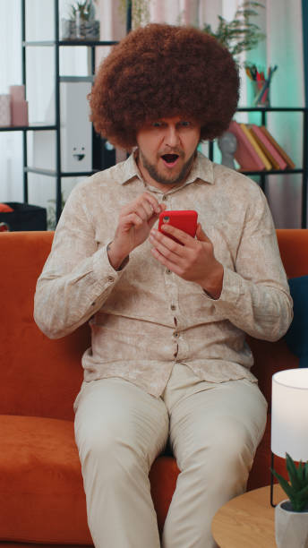 istock Handsome young man at home use smartphone typing browsing, wow yes found out great big win celebrate 1444260596