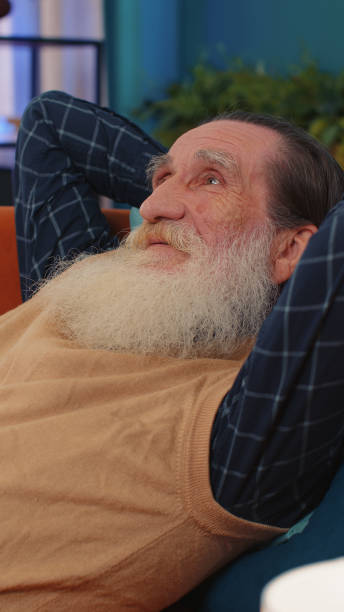istock Tired one senior old man lying down in bed taking a rest at home, napping, falling asleep on sofa 1444261035