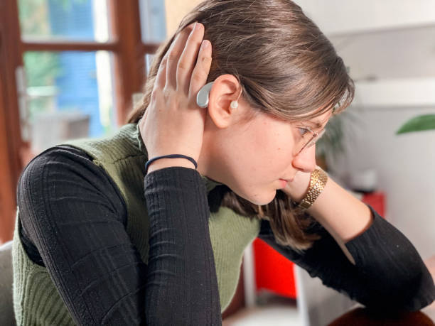 istock Girl showing her hearing aid 1444264720