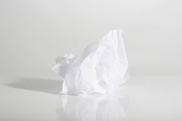 istock crumpled piece of paper against a harsh light white background 1444268311