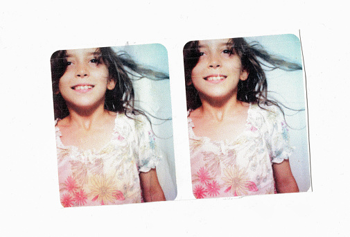 6 year old girl smilling inside a photo booth