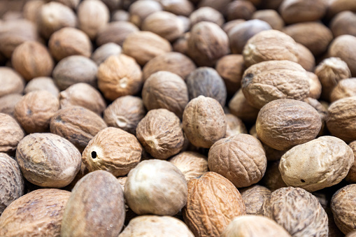 Close up of whole nutmegs as a background.Full Frame.