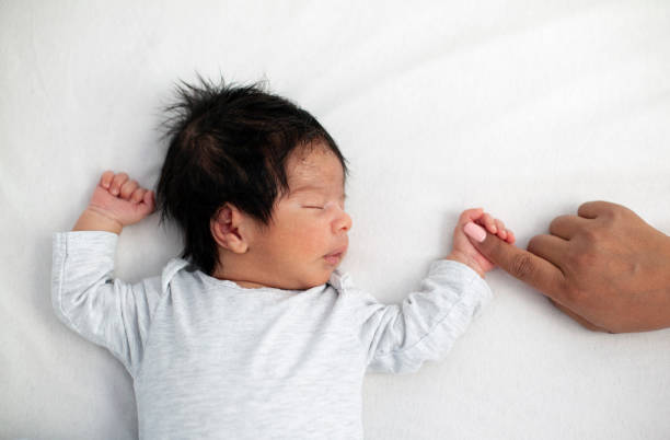 istock Newborn baby securely grasping his mother's finger 1444270930