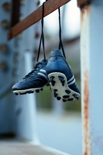 istock Soccer shoes hanging on metal construction. 1444272700