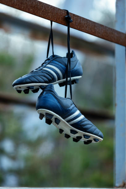 Soccer shoes in an old abandoned place.