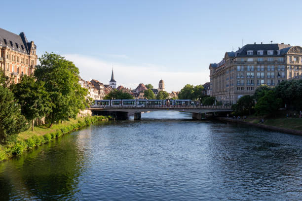 istock River in a French city over which a bridge with a tram passes 1444276073