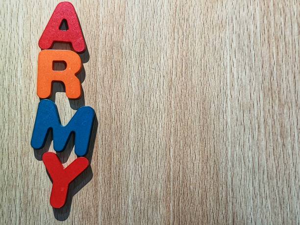Photo of the alphabet on a wooden table that says ARMY. stock photo