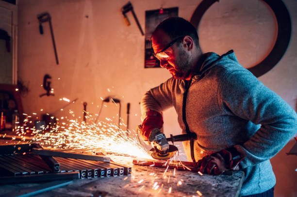 istock Worker in a factory grinding metal with a grinder 1444281728