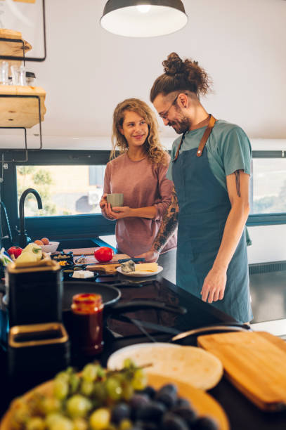 istock Young couple making breakfast together in the kitchen at home 1444281777