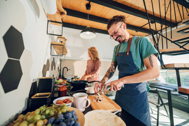 istock Young couple making breakfast together in the kitchen at home 1444281779