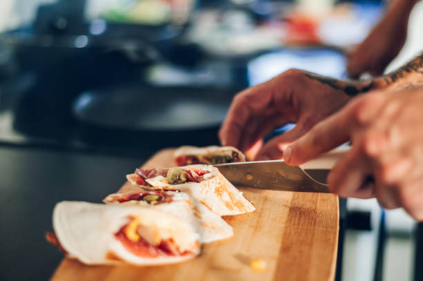 istock Burrito cut on pieces and served on a wooden board for breakfast 1444281837