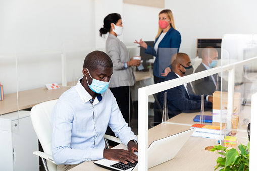 african male happy businessman with medical mask in white room