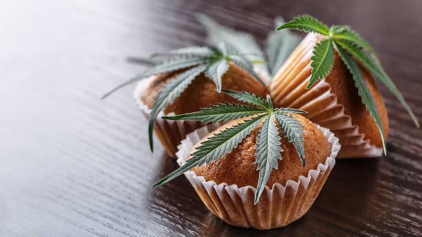 Cupcake with marijuana.traditional sponge cake with cannabis weed cbd. Medical marijuana drugs in food dessert, ganja legalization. stock photo