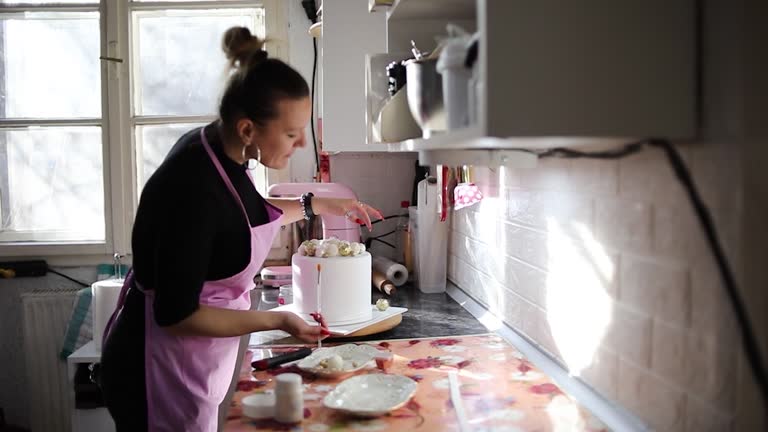 A young woman prepares a cake in her kitchen