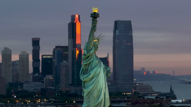 Dramatic Aerial View of the Statue of Liberty and NYC skyline at Dawn