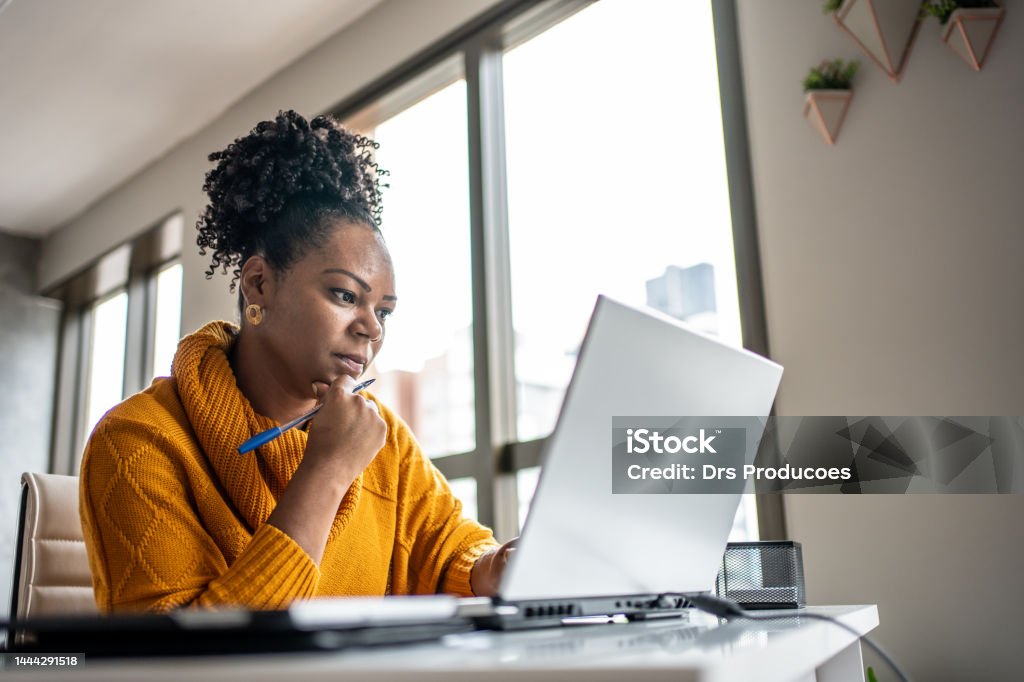 Black woman working from home office Using Computer Stock Photo