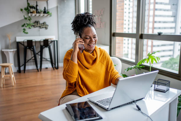 istock Black woman talking on the phone at home 1444291649