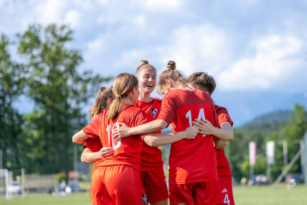 Red team is taking a group hug before the match against blue women's team began