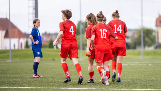 istock Medium group of red soccer team running to one blue member 1444291698