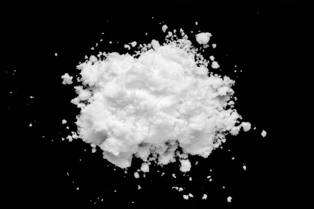 istock White snow isolated on black background close up 1444292385