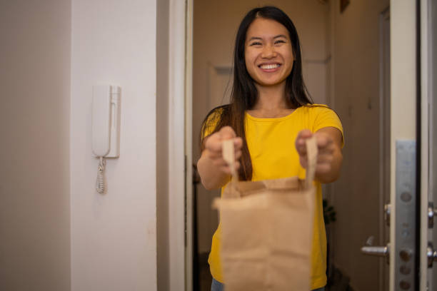 istock Volunteer at the door with the package 1444292426