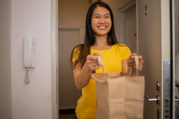 istock Volunteer at the door with the package 1444292433
