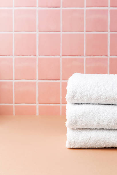 istock White cotton towels on table inside a bathroom wall tiles ceramic background. Copy space 1444312489