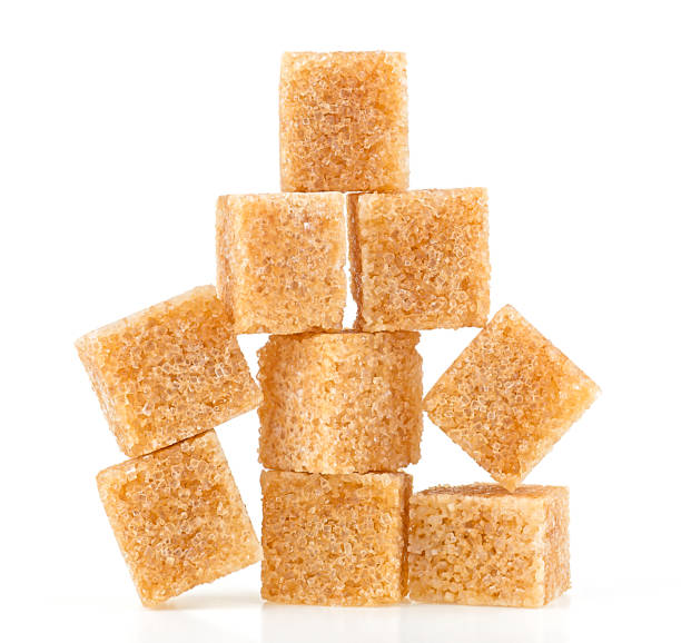 istock Pile of brown cane sugar cubes isolated on a white background. Pyramid. 1444312721