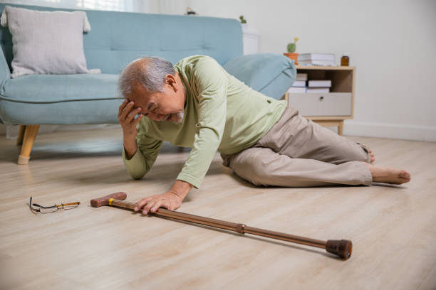 istock Older senior man headache lying on the floor after falling 1444323266
